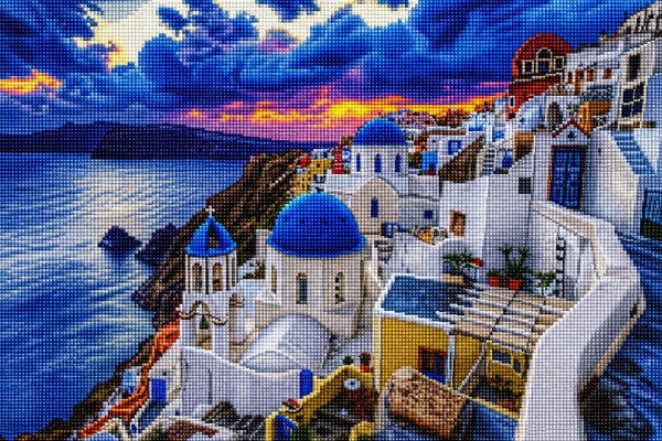 Diamond painting of Santorini at dusk with blue church domes and a sea view. Mockup.