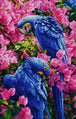Diamond Painting von zwei blauen Papageien inmitten einer Fülle von rosa Blüten.  Mockup.