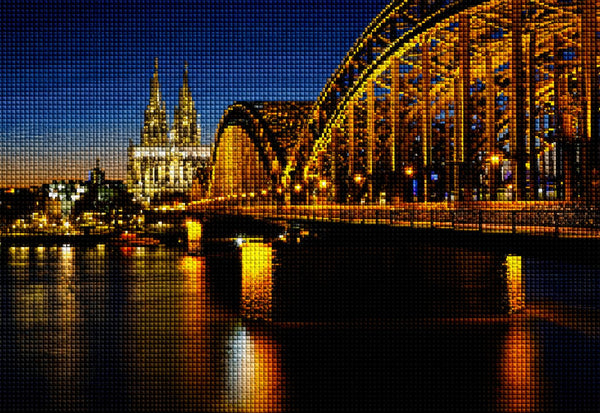 Diamond Painting der Hohenzollernbrücke in Köln mit dem beleuchteten Dom im Hintergrund bei Nacht über dem Rhein. Mockup.
