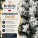 Realistisch wirkende schneebedeckte Zweige des künstlichen Weihnachtsbaums mit dichter winterlicher Optik