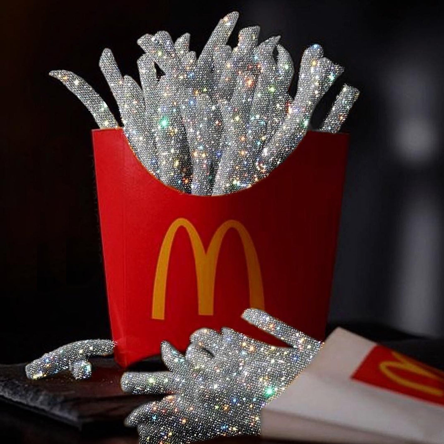 Diamond Painting einer roten Pommes-Schachtel mit silber glitzernden Pommes frites aus Diamanten.